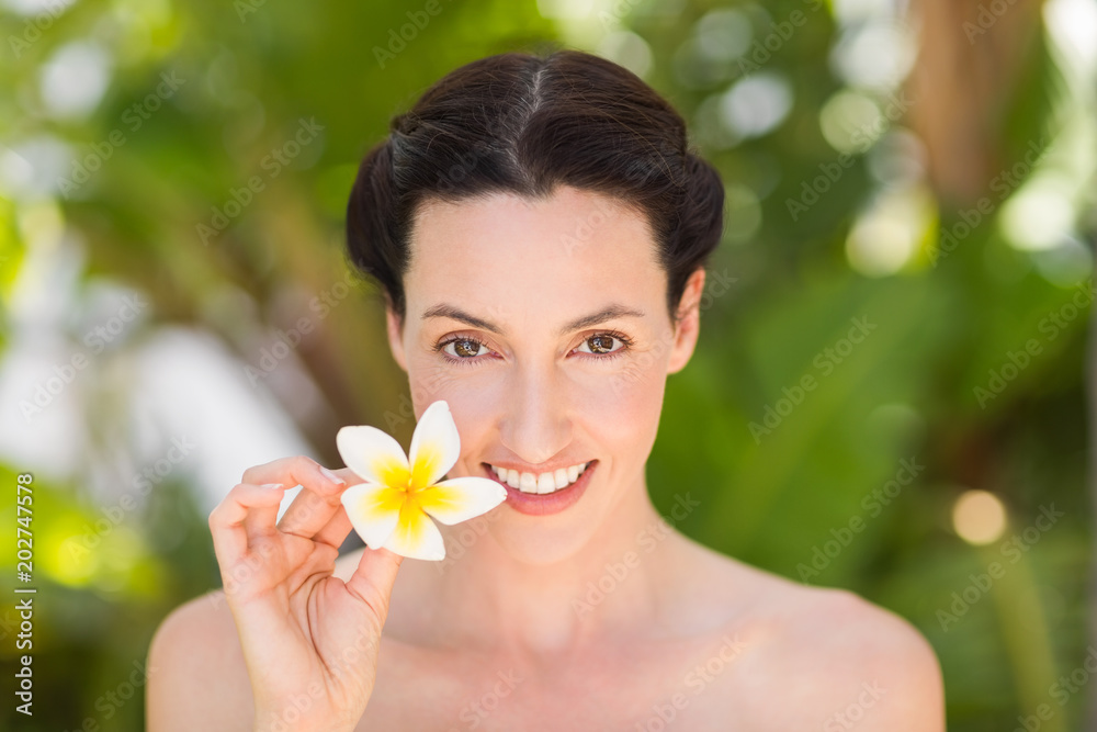 Happy brunette holding a white flower Happy brunette holding a white flower