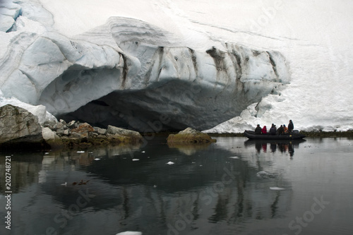 Larsen Harbour South Georgia Islands, tourists in rubber boat on harbor near glacier photo