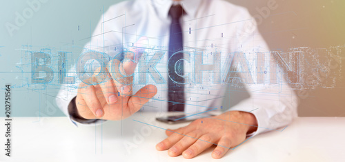 Businessman holding a Blockchain title isolated on a background