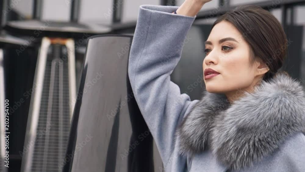 Street photo shoot of a girl in a coat. Photoshoot for the catalog of a