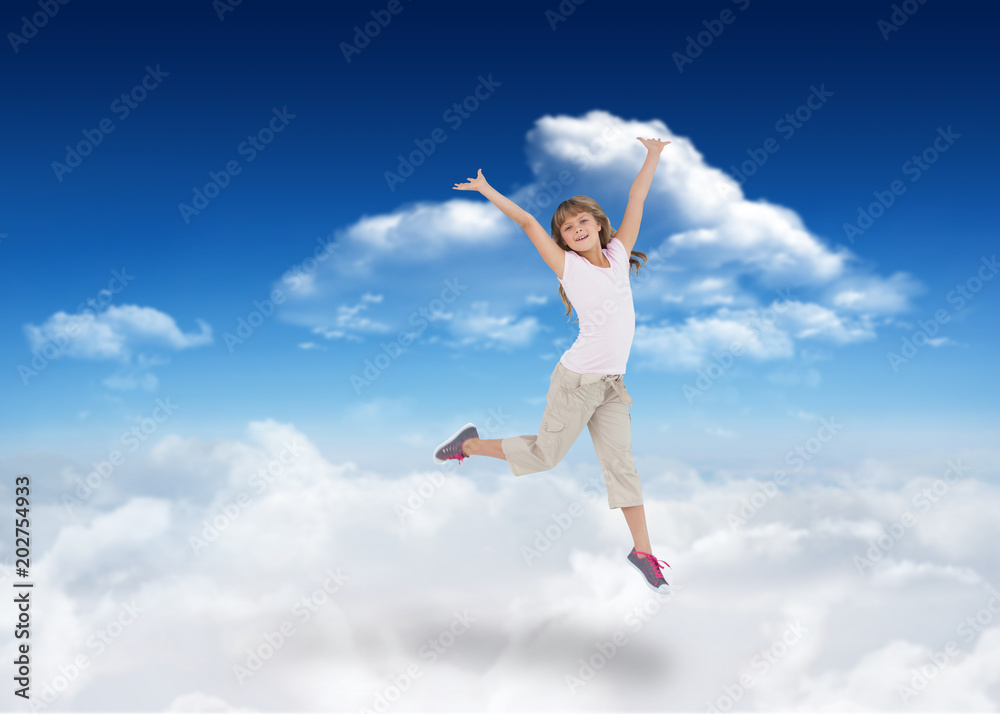 Happy girl jumping against bright blue sky with clouds