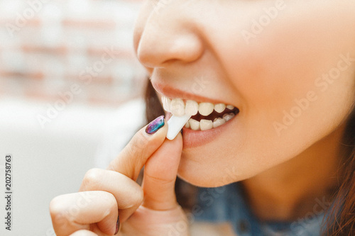 close up on a beautiful girl while enjoying a chewing gum after lunch photo