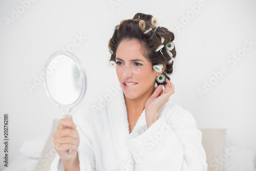 Pretty natural brunette looking at mirror