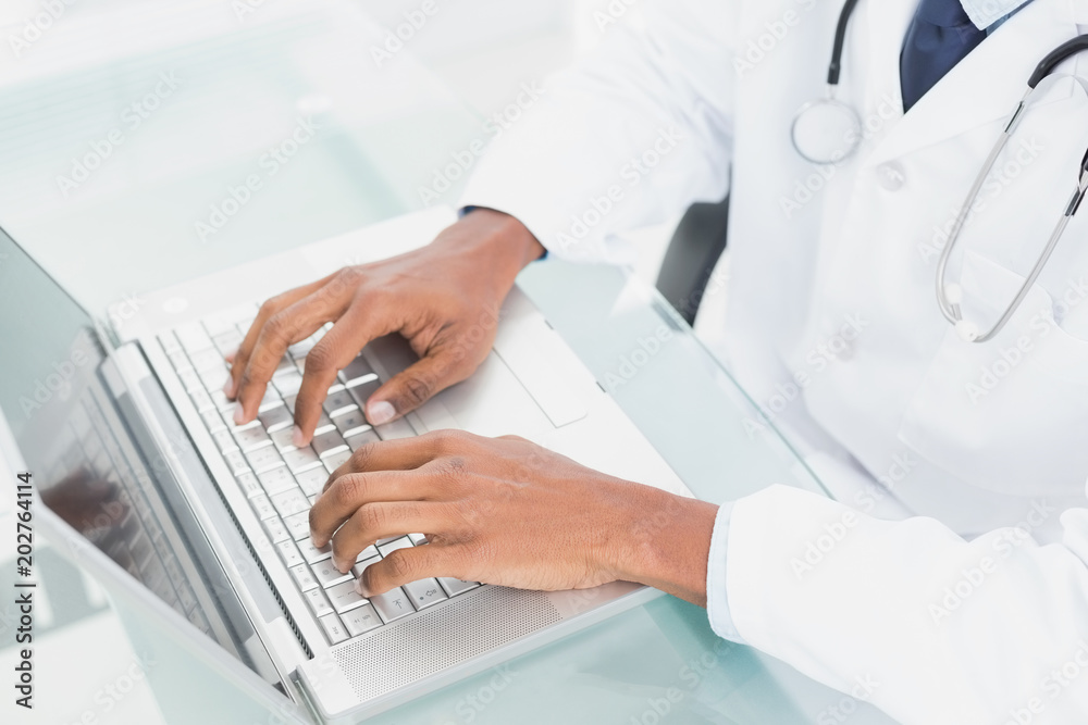 Hands using laptop at medical office Hands using laptop at medical office
