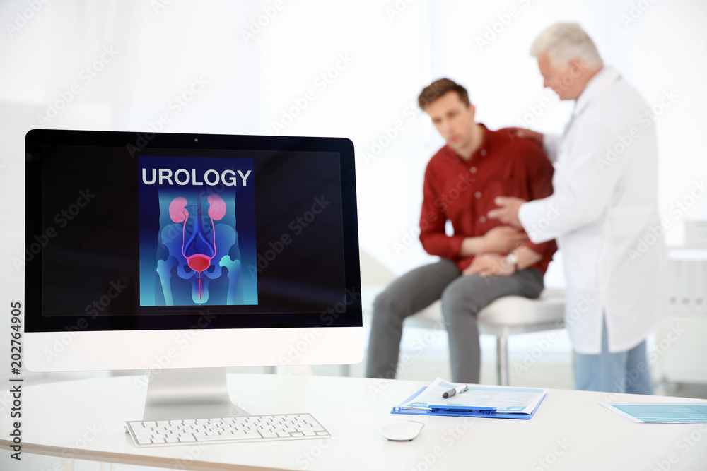 Computer monitor with word UROLOGY and people on background