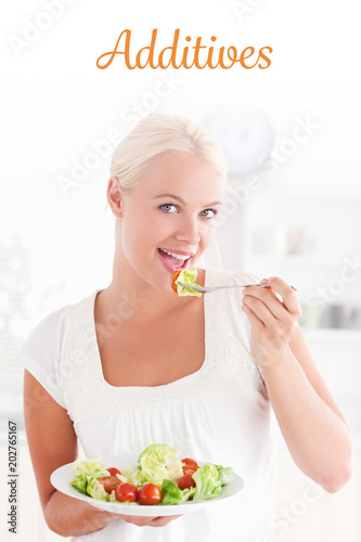 The word additives against woman eating a salad