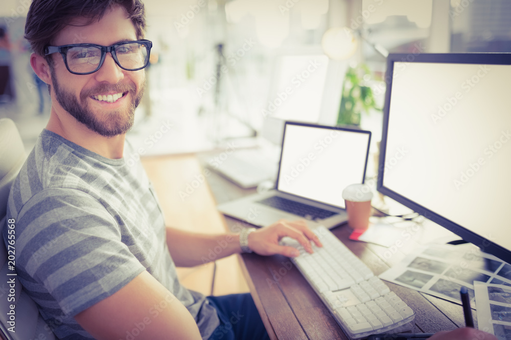 Casual businessman using computer in office Casual businessman using computer in office