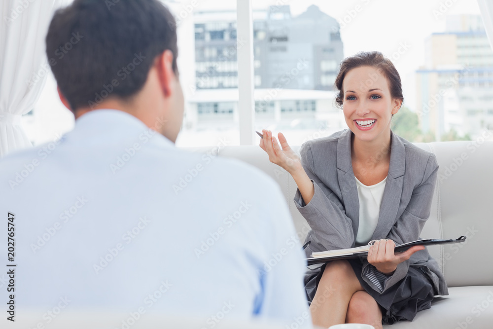 Cheerful businesswoman talking to her colleague Cheerful businesswoman talking to her colleague