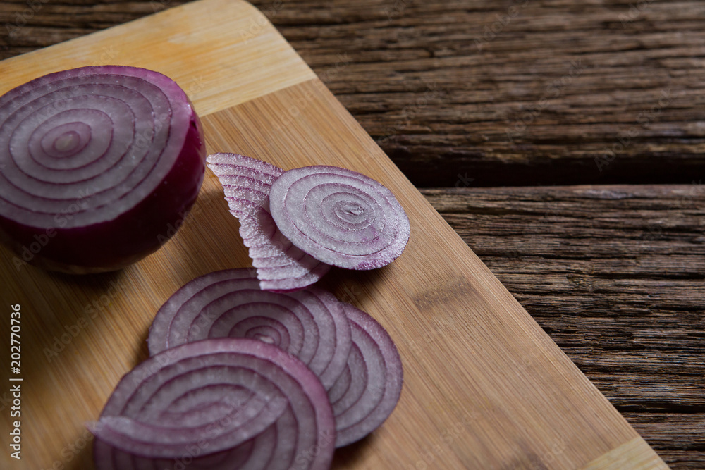 Sliced onions on chopping board