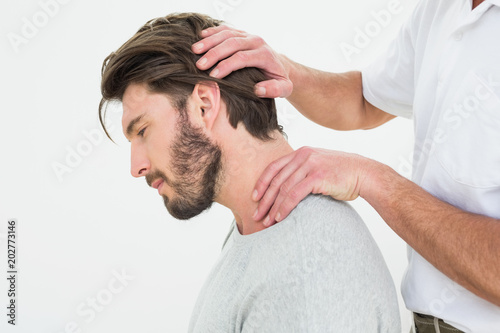 Εκτύπωση καμβά Side view of a man getting the neck adjustment done