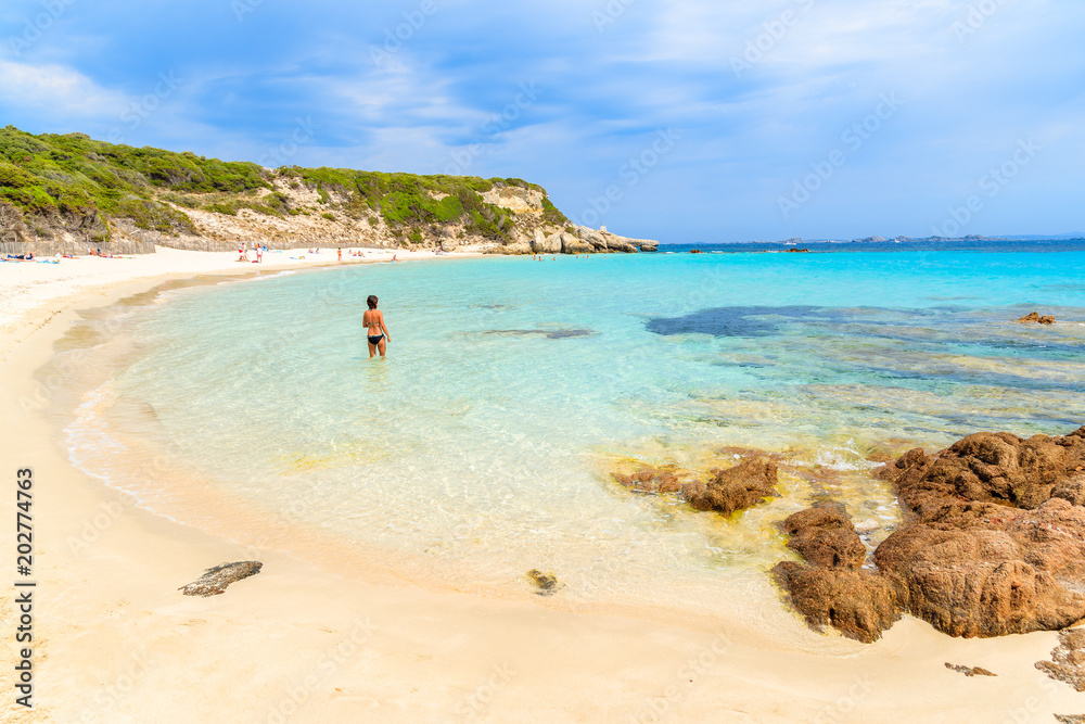 Unidentified young woman on Grande Sperone beach, Corsica island, France Unidentified young woman on Grande Sperone beach, Corsica island, France