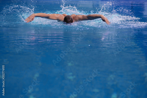 Male swimmer at the swimming pool. Underwater photo. Male swimmer.