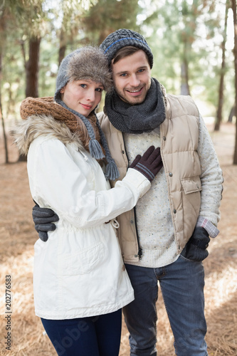 Loving couple in winter clothing in the woods