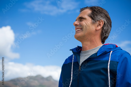 Smiling man looking away while standing
