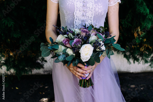  lavender bouquet in the hands of the bride