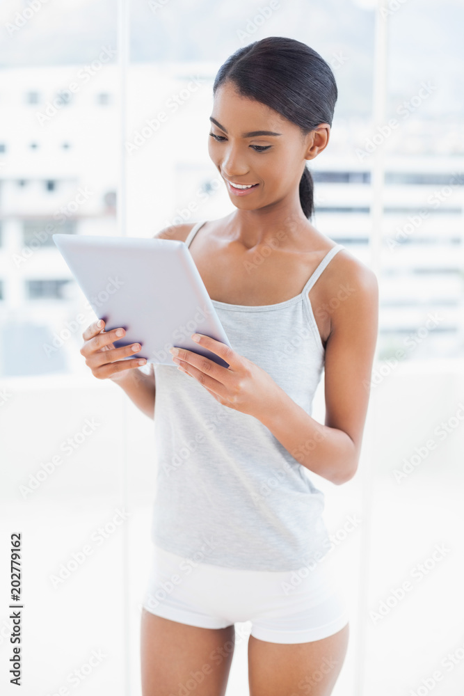 Peaceful sporty model holding tablet computer Peaceful sporty model holding tablet computer