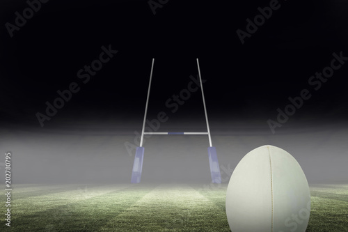 Close-up of rugby ball against rugby pitch