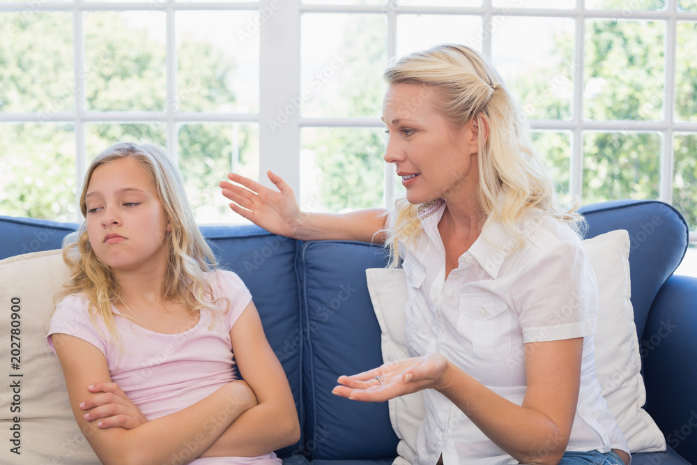 Mother scolding daughter on sofa Mother scolding daughter on sofa
