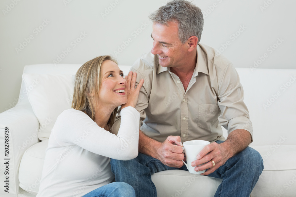 Couple with coffee cup in living room Couple with coffee cup in living room