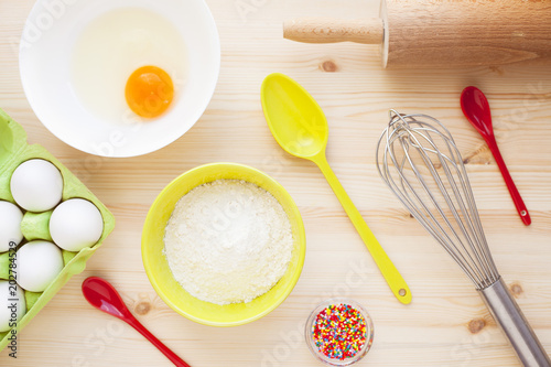 Ingredients for baking on the wooden background. Сookery, food, confectionery and home kitchen concept. Top view. Close up.