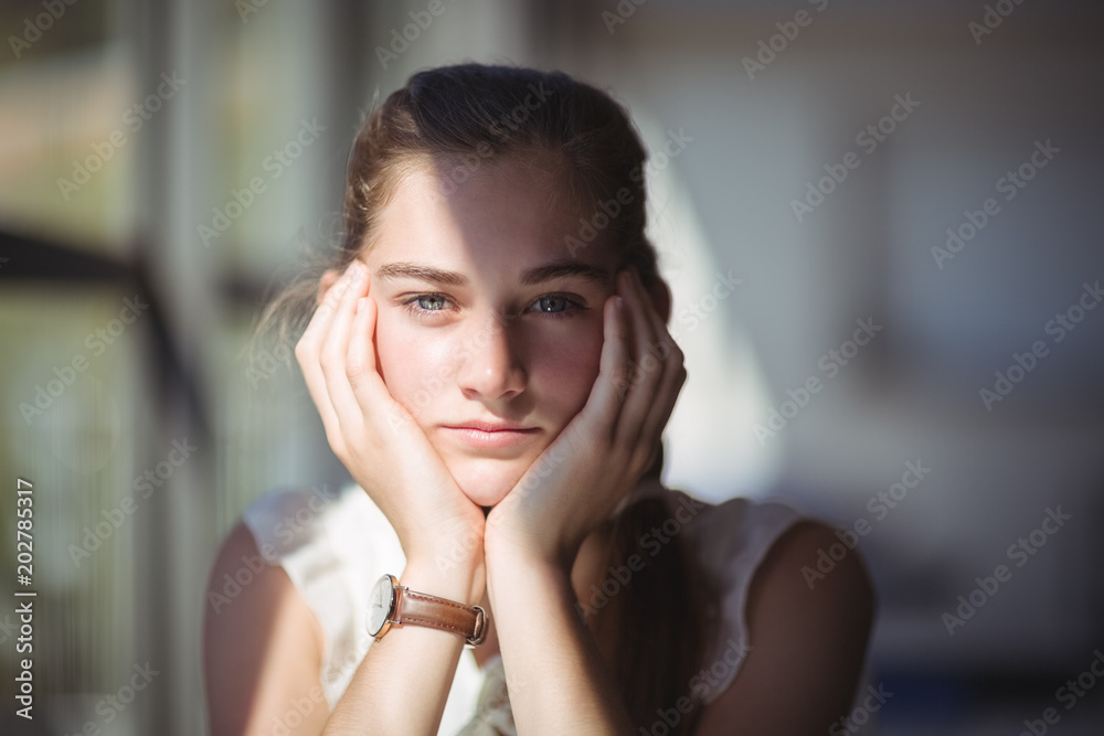 Pretty schoolgirl sitting in classroom Pretty schoolgirl sitting in classroom