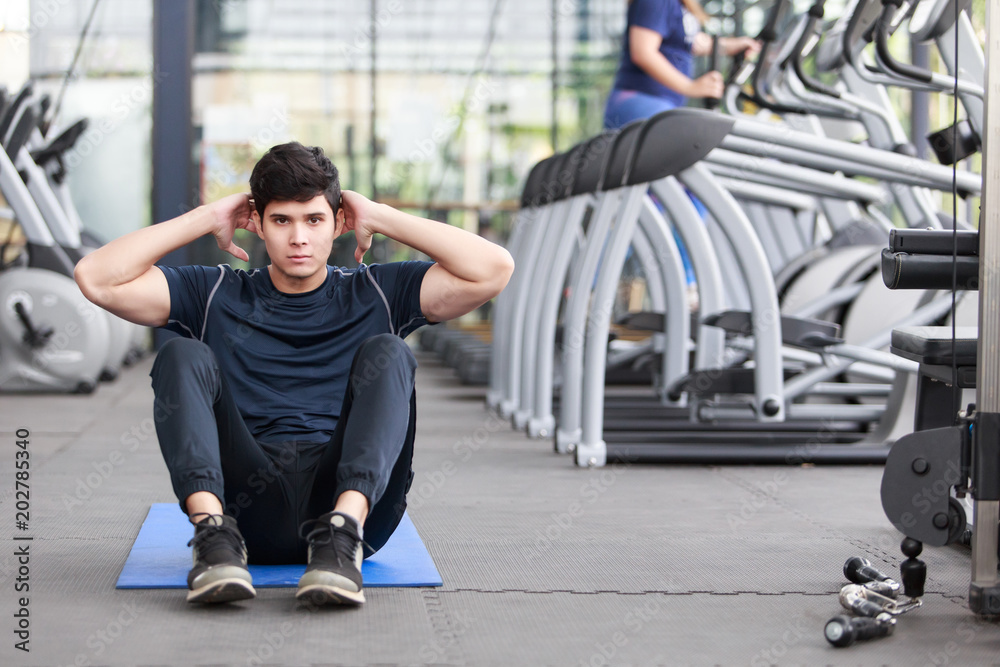 Φωτογραφία Asian man exercising in the gym, fitness, health, body good.