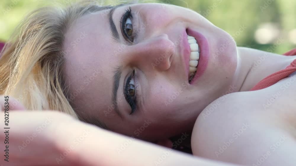 Attractive Blonde Woman Lying In The Park, Flirting With Camera
Attractive Blonde Woman Lying In The Park, Flirting With Camera