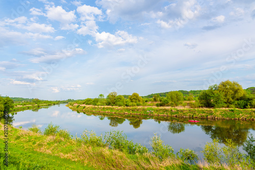 View of Vistula river and green fields near Krakow city in springtime, Poland