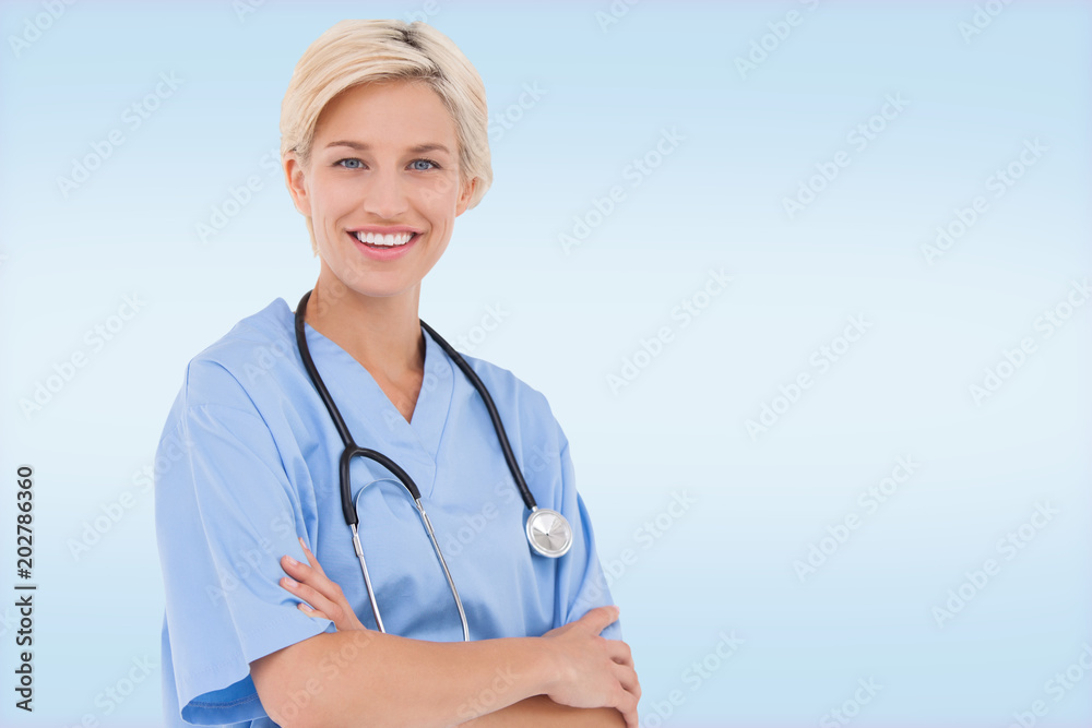 Blonde doctor smiling at camera against blue vignette background Blonde doctor smiling at camera against blue vignette background