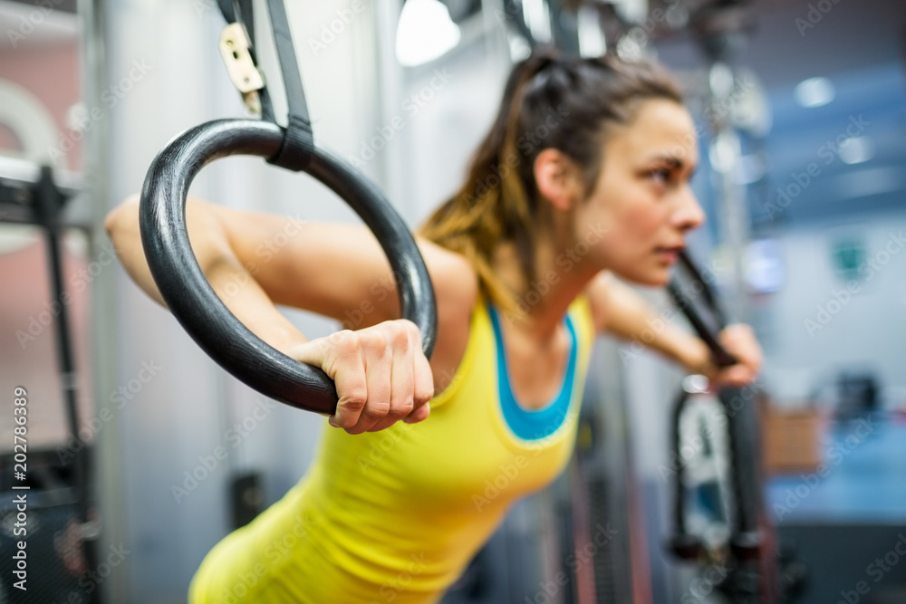 Fototapeta premium Smiling woman exercising her arms
