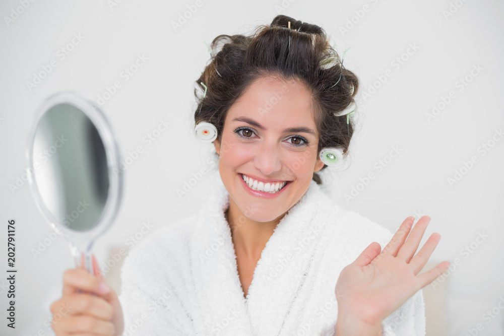 Cheerful natural brunette holding mirror and waving Cheerful natural brunette holding mirror and waving