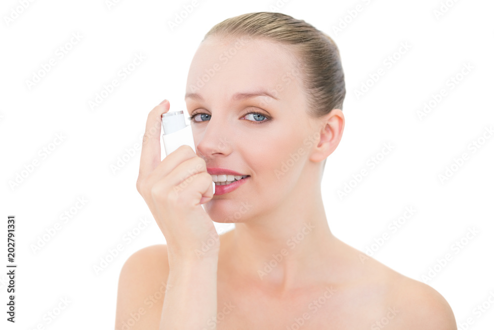 Natural pretty blonde model using an asthma inhaler Natural pretty blonde model using an asthma inhaler