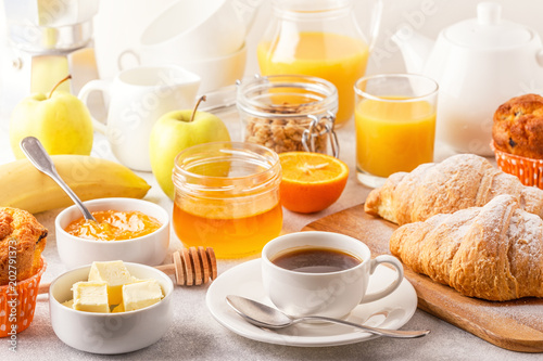 Continental breakfast with fresh croissants, orange juice and coffee photo