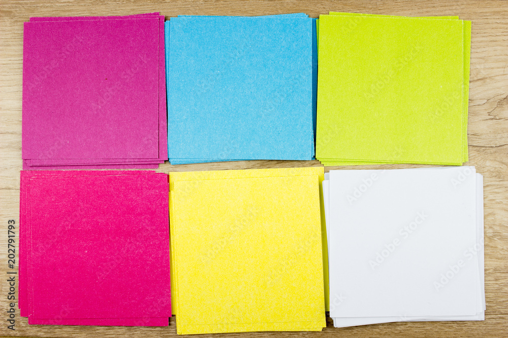 Fototapeta premium Сolorful paper blanks, Office concept. Empty space for design and text, wooden background