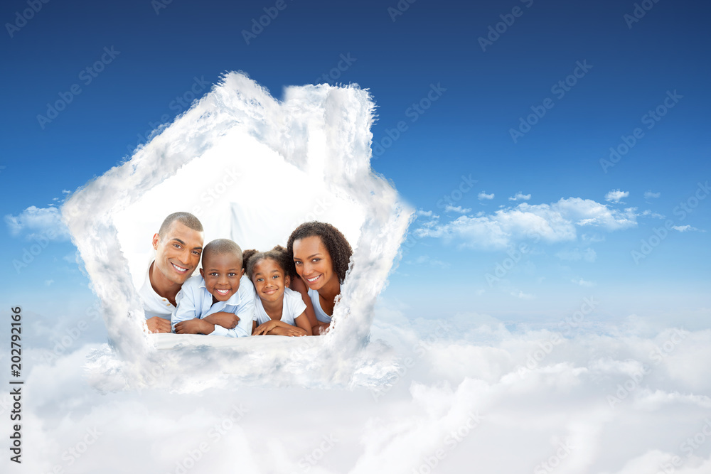 Happy family having fun lying down on bed against bright blue sky over clouds Happy family having fun lying down on bed against bright blue sky over clouds