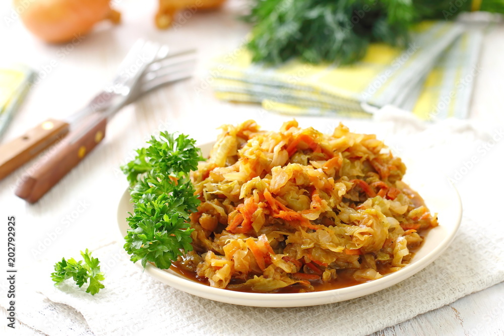 Stewed cabbage served on the table and prepared for eating. Vegetarian food Stewed cabbage served on the table and prepared for eating. Vegetarian food
