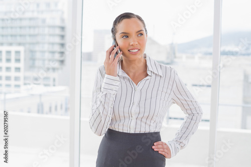 Cheerful businesswoman talking on phone