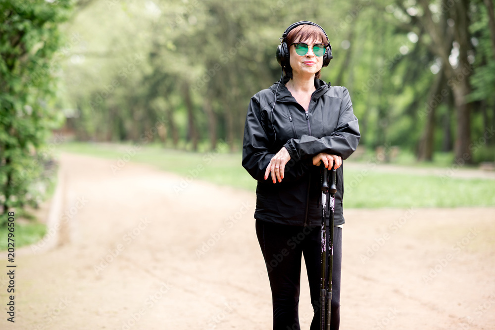 Woman walking with hiking sticks Woman walking with hiking sticks