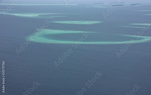 Aerial view of atolls from seaplane, flight from South Ari Atoll to North Male Atoll, Maldives photo