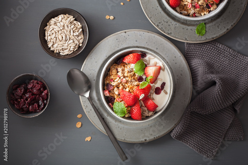 granola and yogurt with seeds and strawberry for breakfast