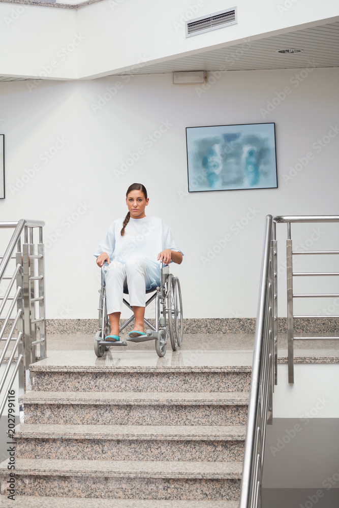 Female patient sitting on a wheelchair Female patient sitting on a wheelchair