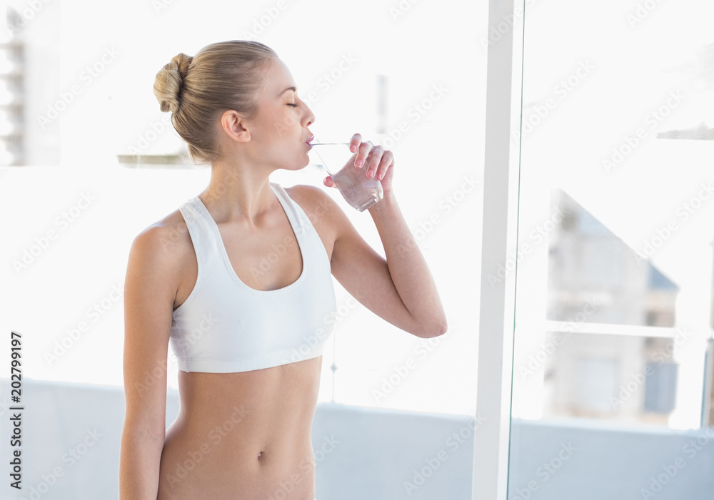 Peaceful young blonde model drinking water Peaceful young blonde model drinking water