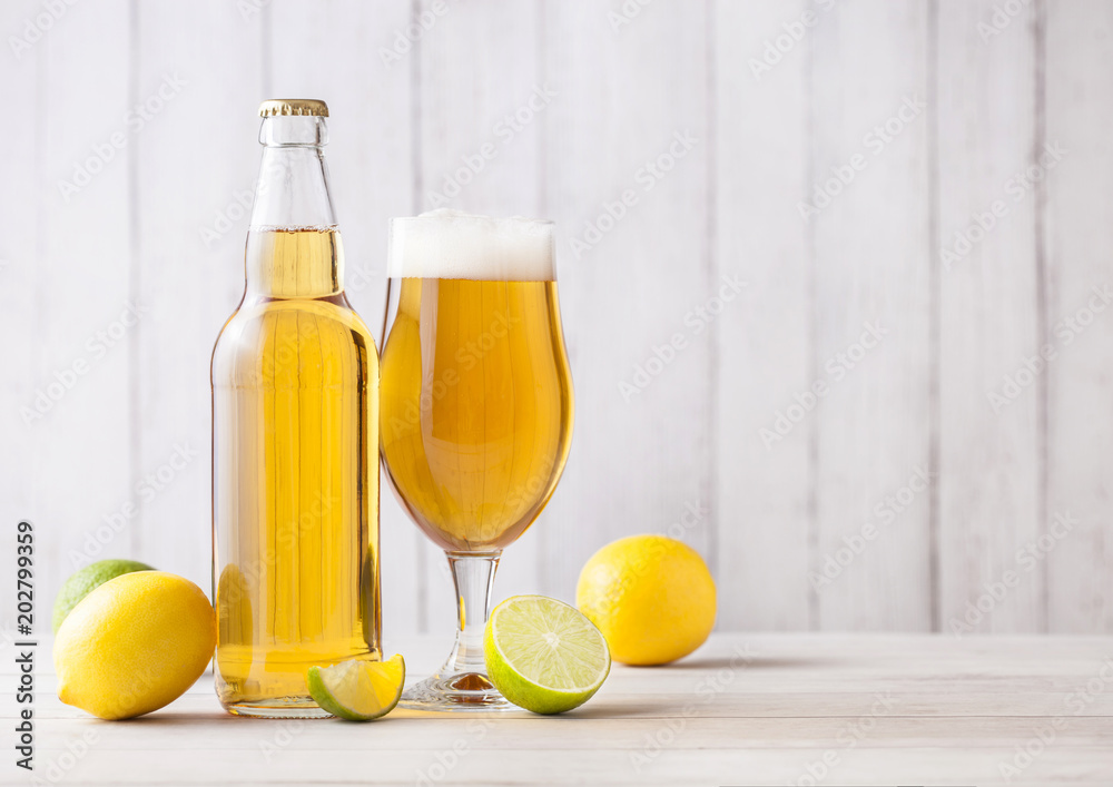 Φωτογραφία Bottle and glass of lager beer with lemon and lime