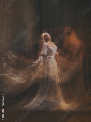 The legend of the Banshee fairy. Pale girl blonde, like a ghost, in a white  vintage dress, flies, hovers in space. Branch of the soul. Light angel.  Gothic, art photo of the