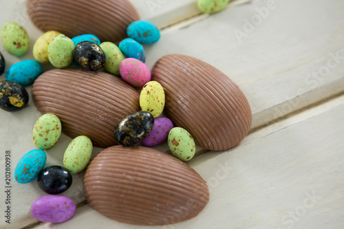 Chocolate Easter eggs on wooden plank