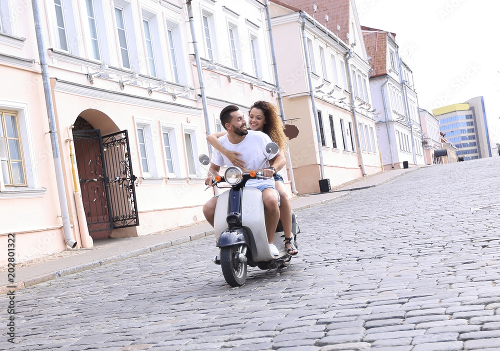 Full length side view of happy couple riding on retro motorbike