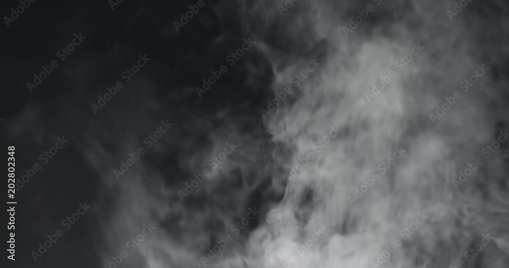 slow motion vapor steam rising over black background slow motion vapor steam rising over black background