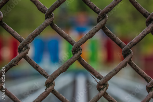 metal fence and unfpcused colorful background