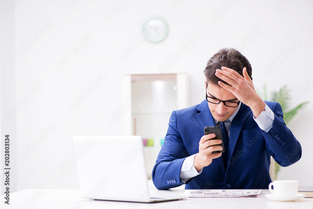 Businessman employee talking on the office phone Businessman employee talking on the office phone