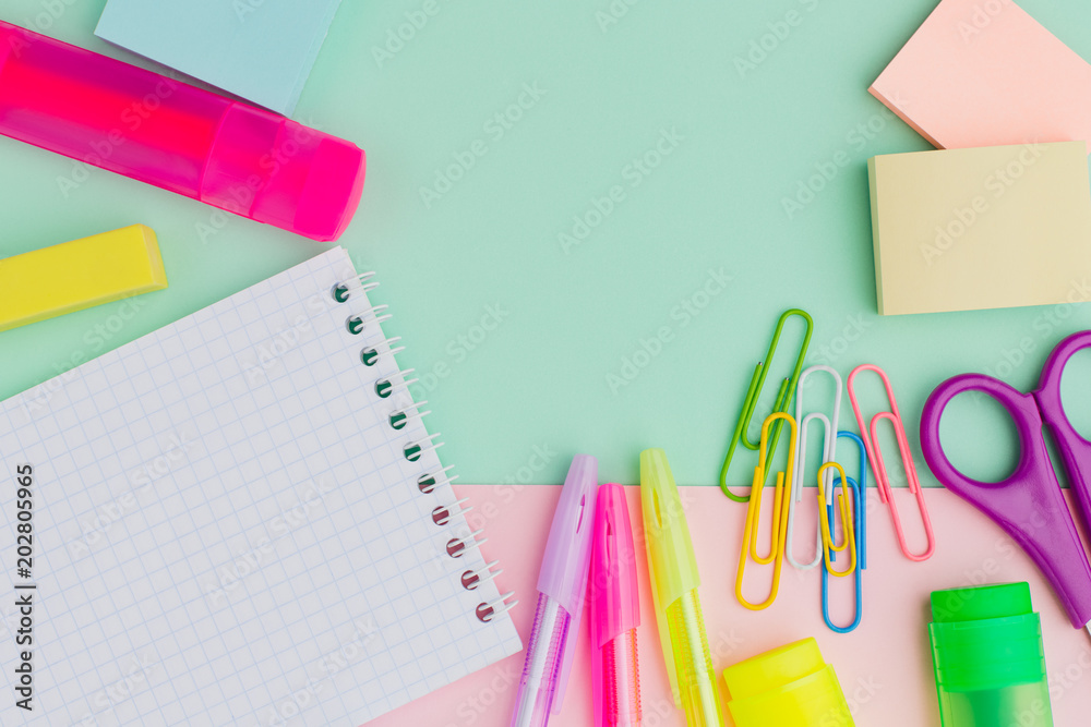 Flat lay lots of stationery on mint pink background, pens, stickers, Notepad, paper clips, markers, erasers, scissors. The concept of preparing children back to school. Copy space. Flat lay lots of stationery on mint pink background, pens, stickers, Notepad, paper clips, markers, erasers, scissors. The concept of preparing children back to school. Copy space.
